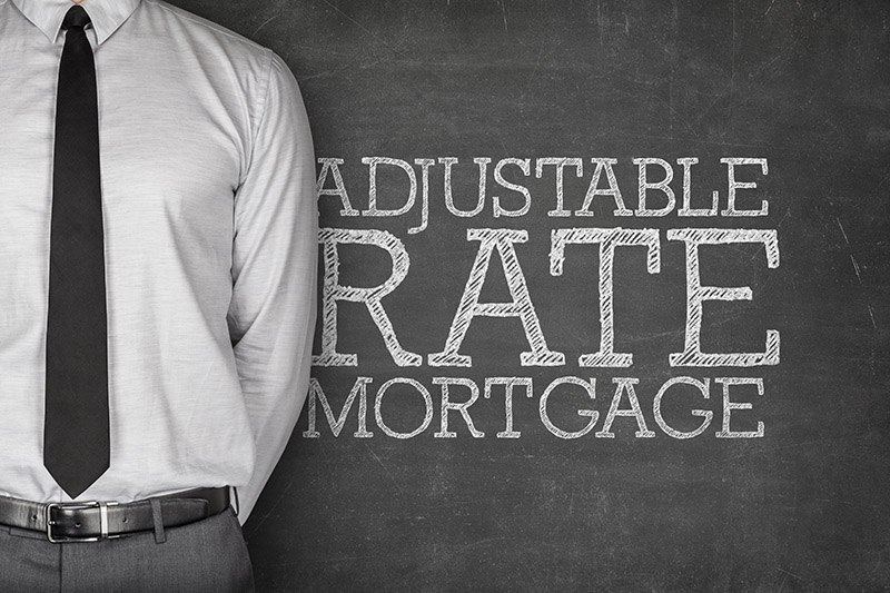 An unseen broker discussing the pros & cons of adjustable rate mortgages.