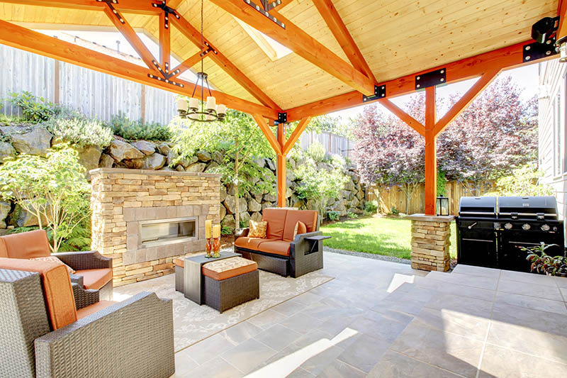 A home with a beautiful backyard hardscape patio and gazebo.