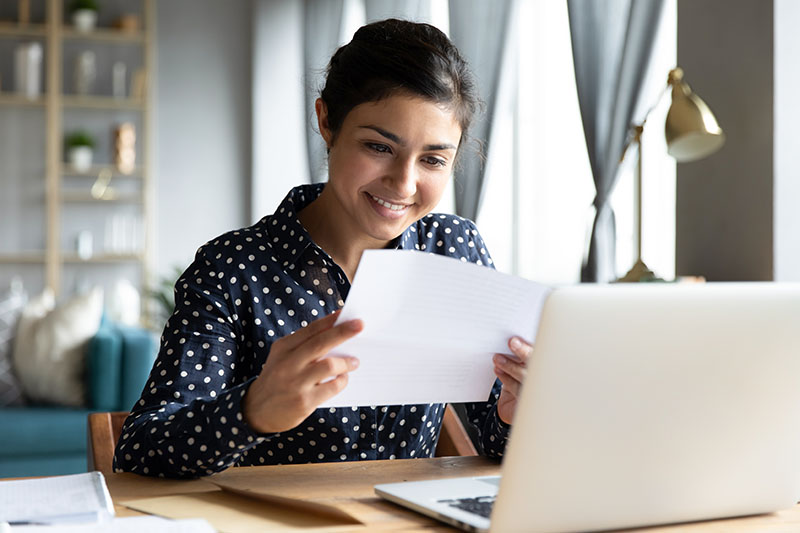 A woman uses her tax return to pay down her mortgage.